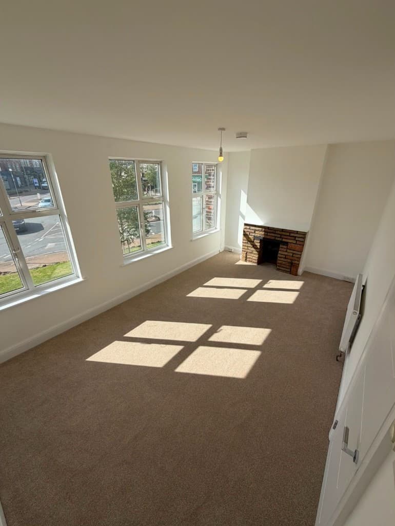 Same living room after refurbishment, with fresh décor and new flooring